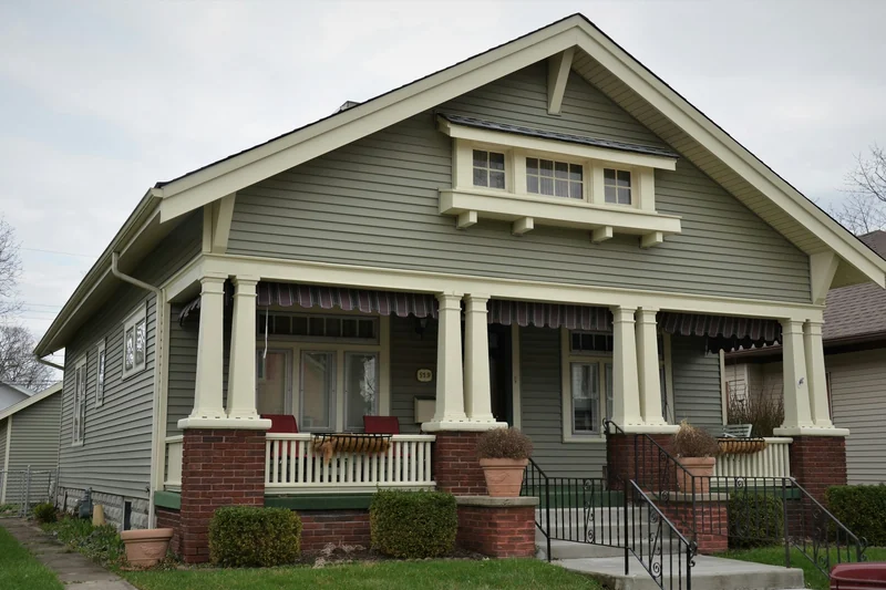 Craftsman bungalow with tapered porch columns, brick piers, and gabled roof